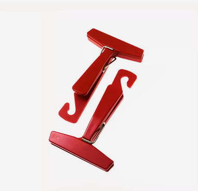 A pair of red 35mm film hanging clips